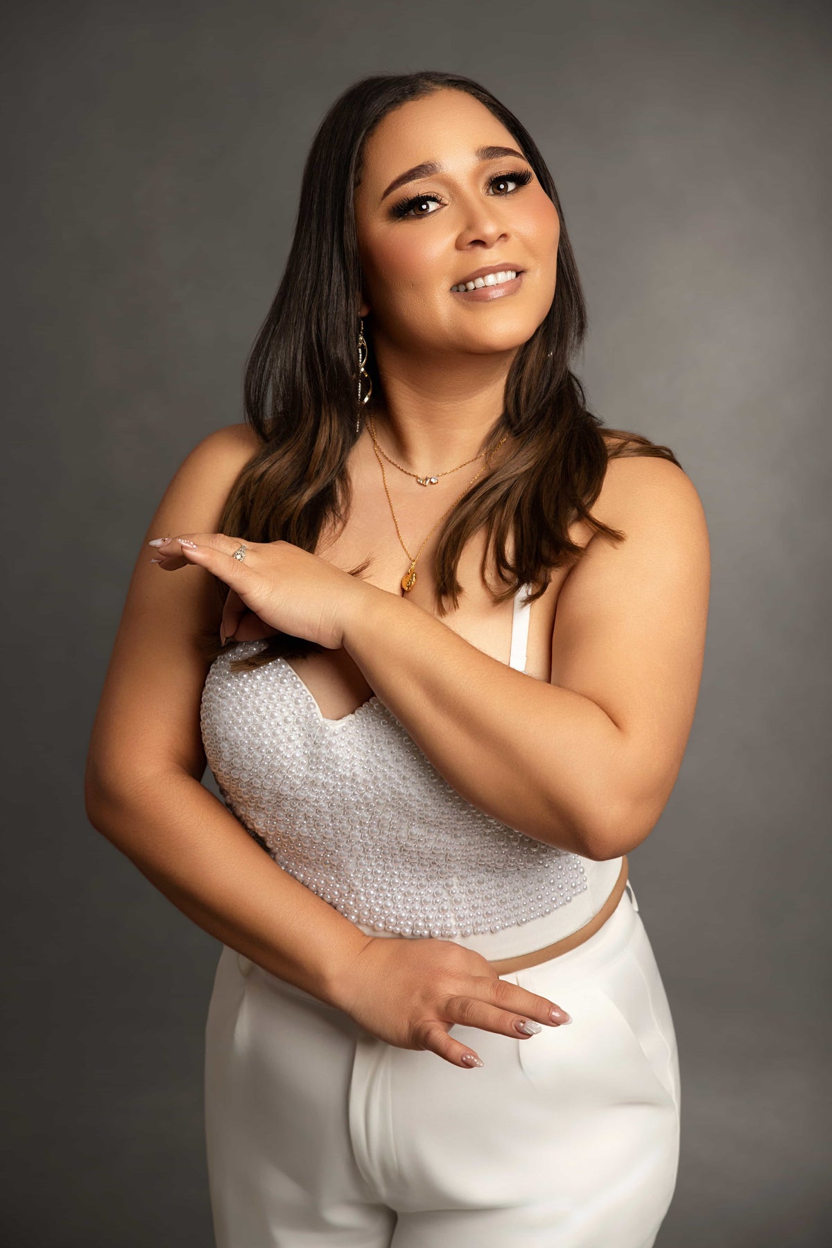 Woman wearing a white outfit with a gray background