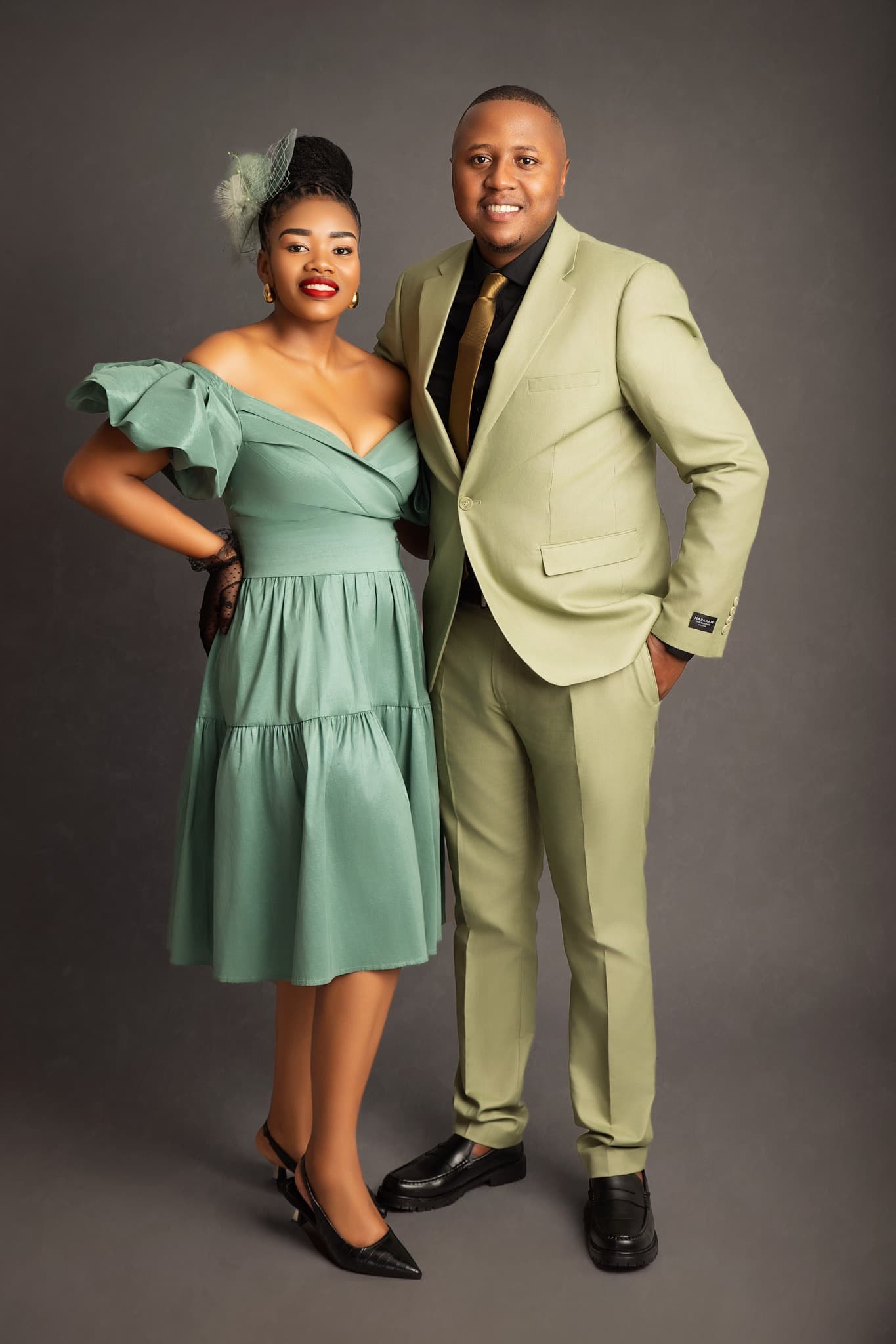 Man and Women wearing sage green striking a pose for a couple shoot