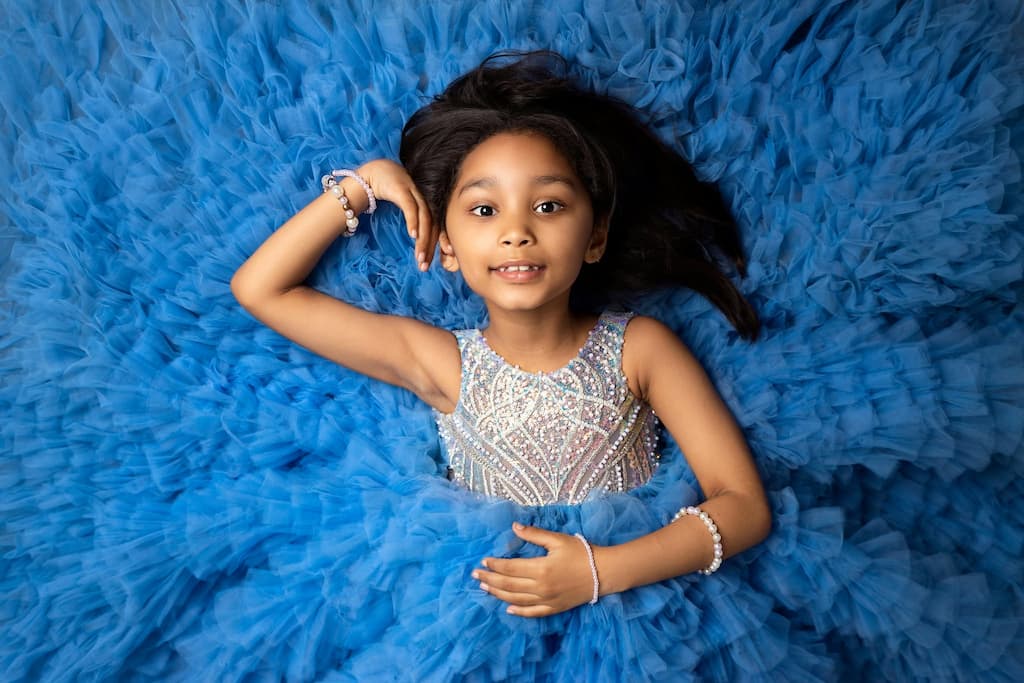 A girl wearing a princess dress with sequince