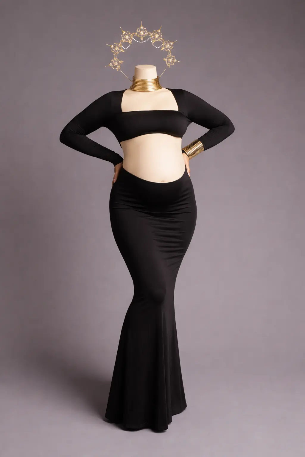 Black dress on a mannequin against a gray background