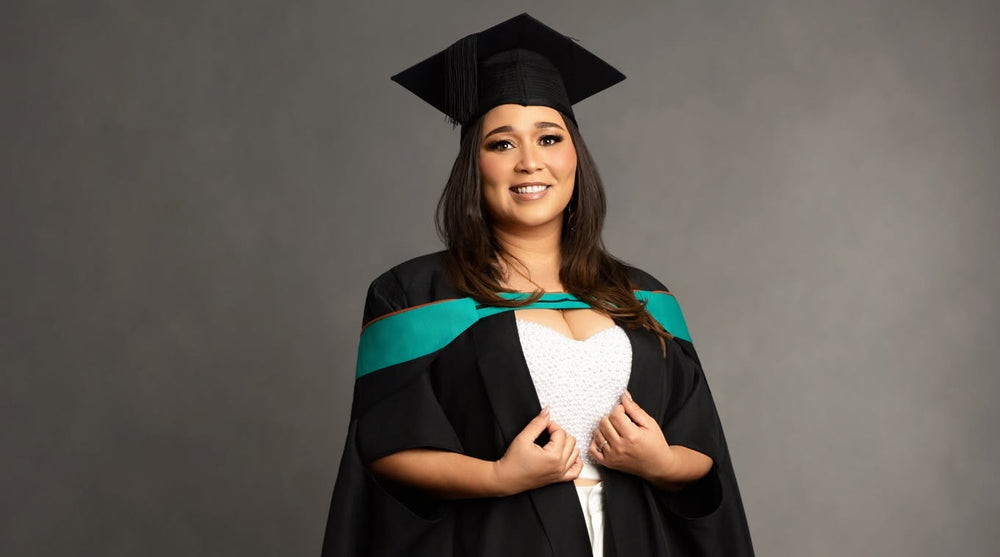 Graduation and achievement photography in Cape Town – graduate wearing a cap and gown at LiMia Photography studio.
