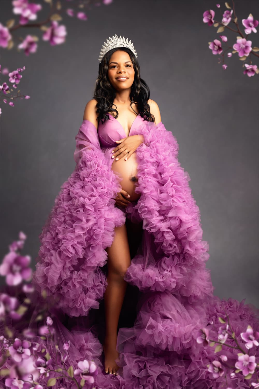 Elegant maternity portrait of a stunning mom-to-be wearing a luxurious fluffy gown and crown, radiating beauty and grace in a serene studio setting. Captured by LiMia Photography, a Maternity Photographer Cape Town, highlighting the beauty of motherhood.