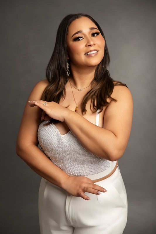 Woman wearing a white outfit with a gray background
