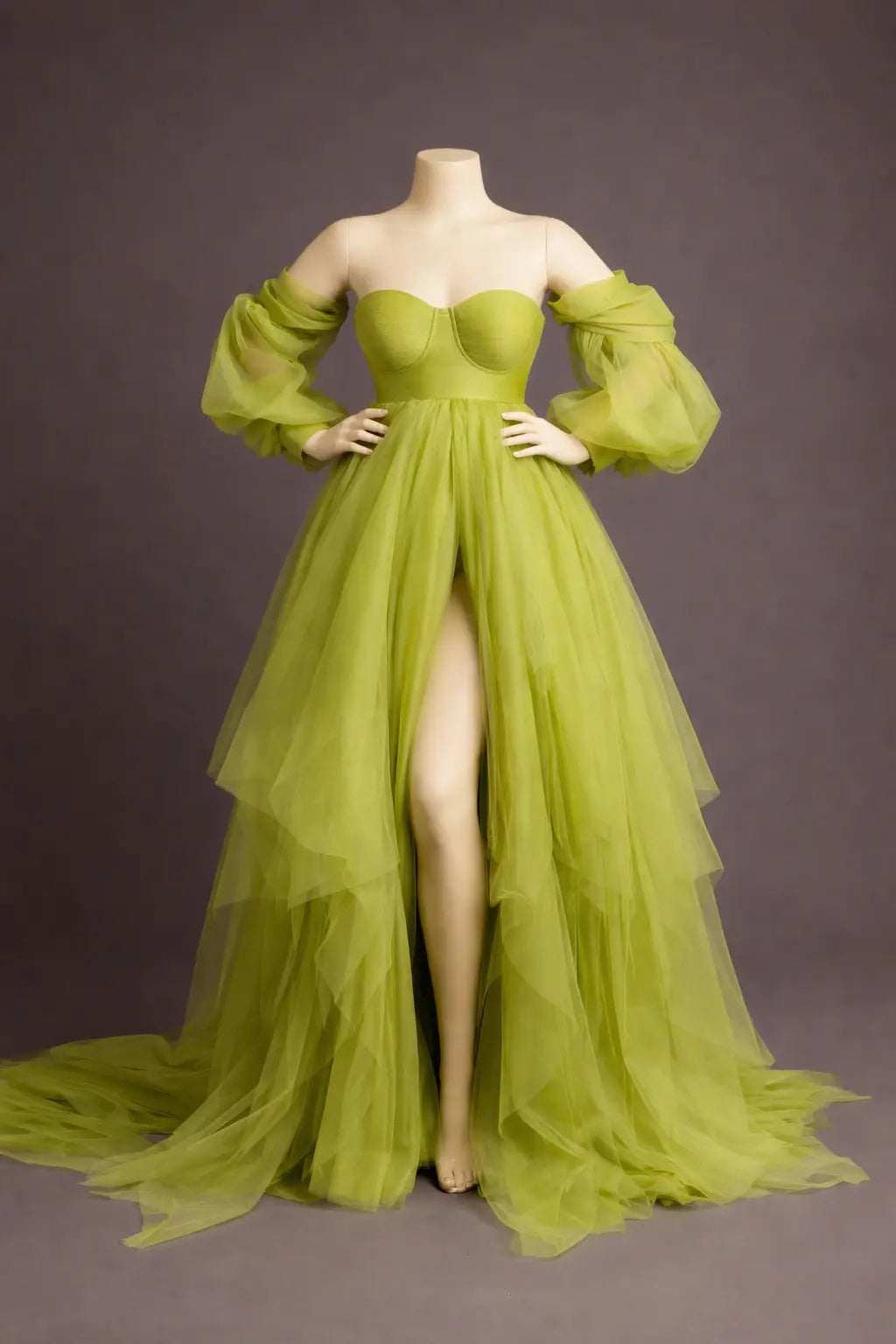 Green evening gown on a mannequin against a gray background