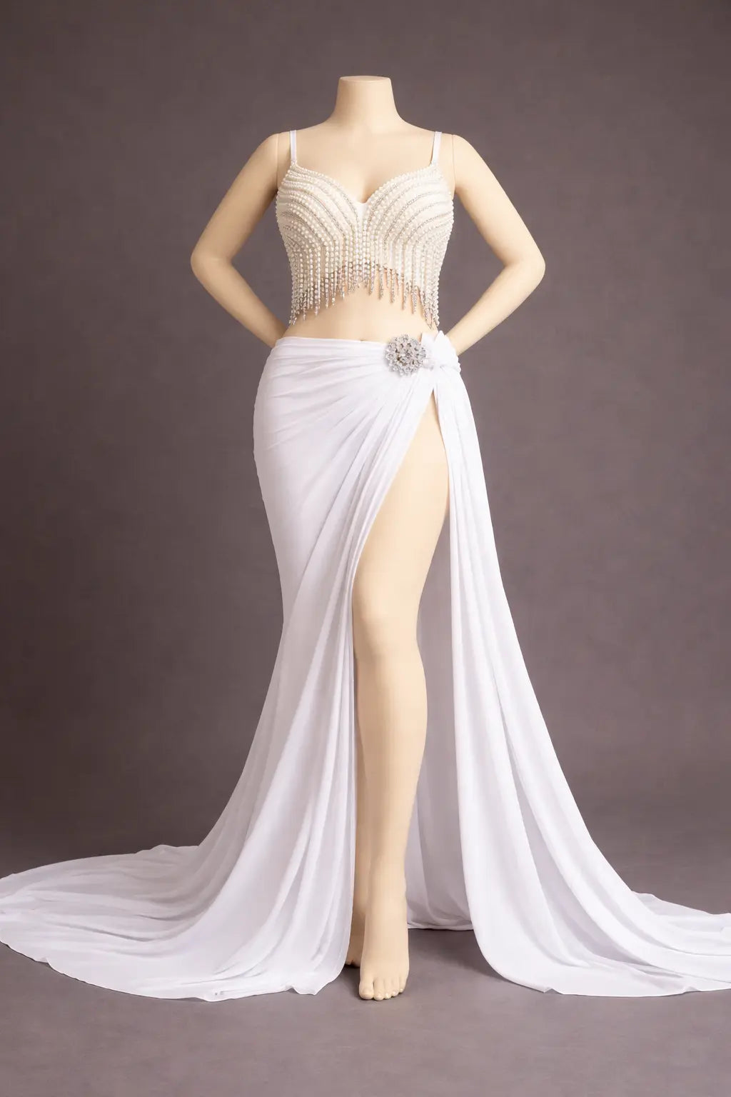 Mannequin wearing a white evening gown with a high slit on a gray background